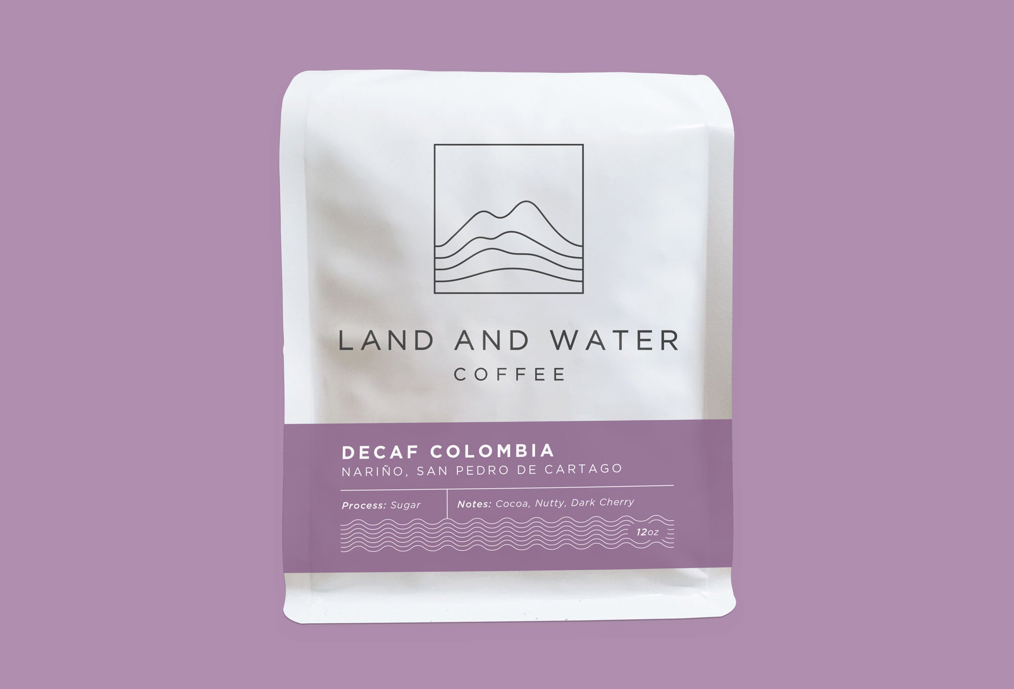 Land and Water Coffee Sugar Decaf Colombia, white bag with purple label and purple background